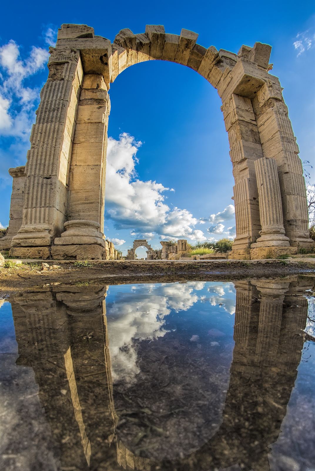 Columns of Leptis Magna reflected in water